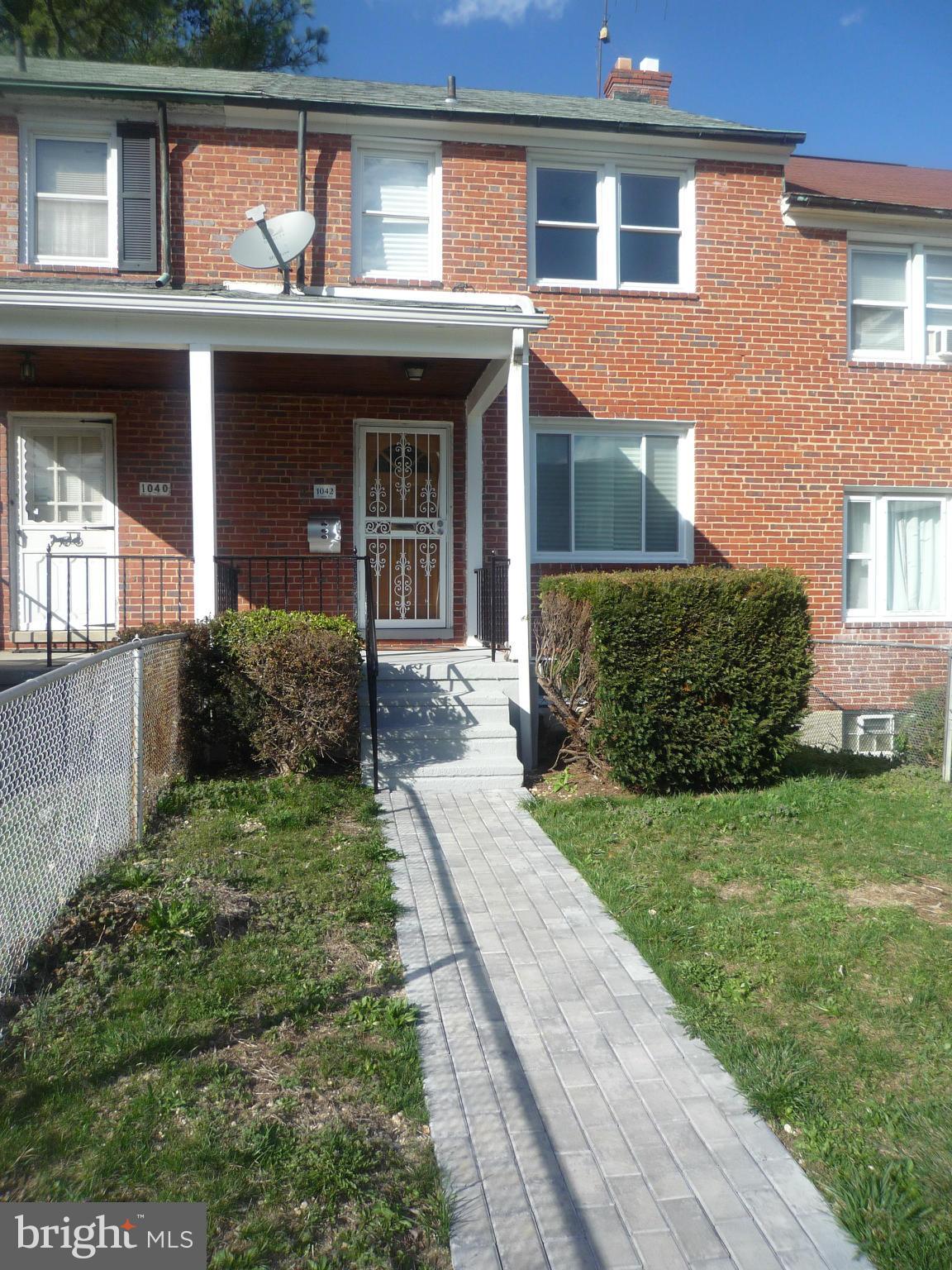 1042 Upnor Road Baltimore, MD 21212 - Photo 2 of 30 front view of a house with a yard
