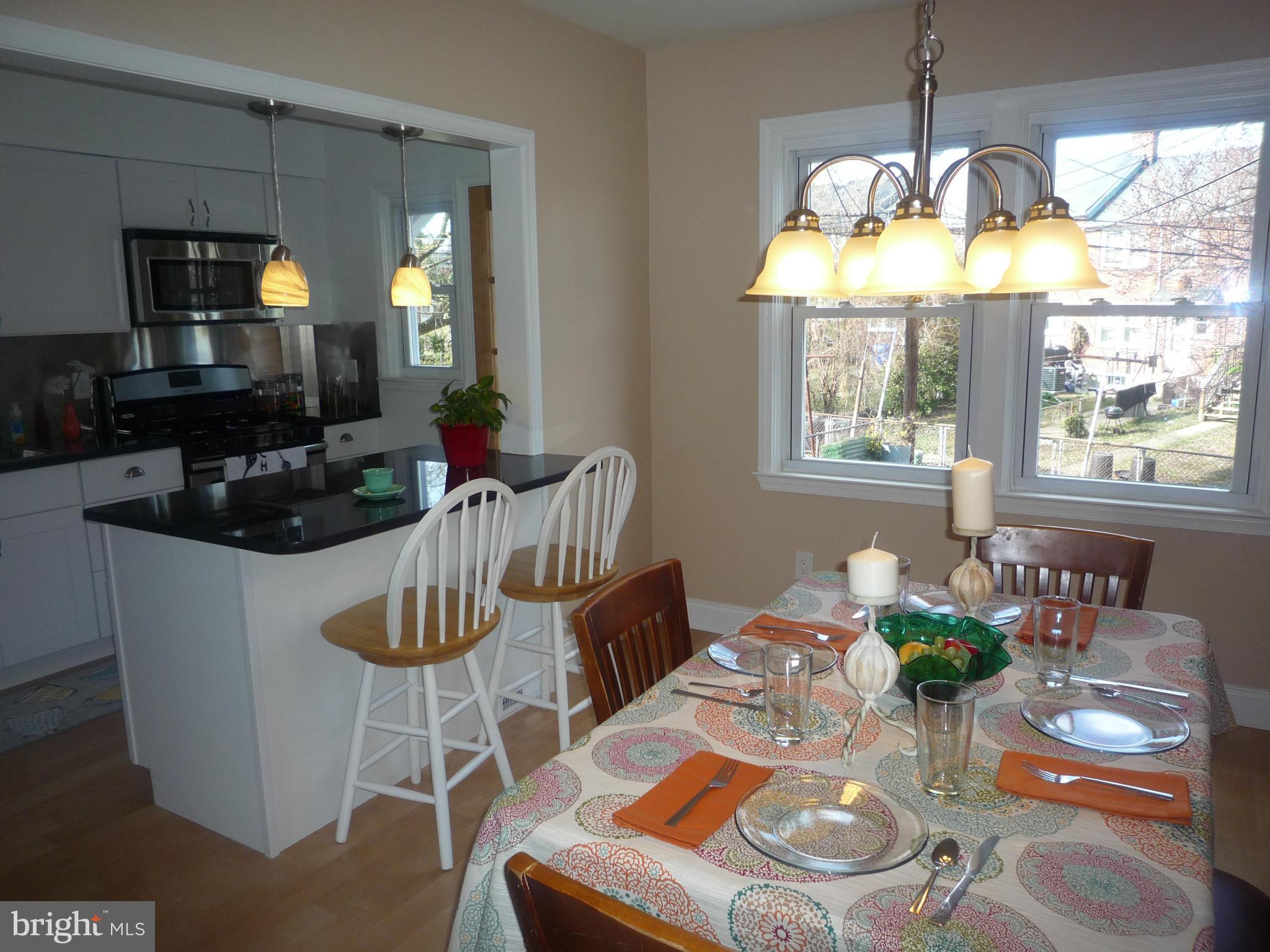 1042 Upnor Road Baltimore, MD 21212 - Photo 11 of 30 a kitchen dining table chairs and a chandelier