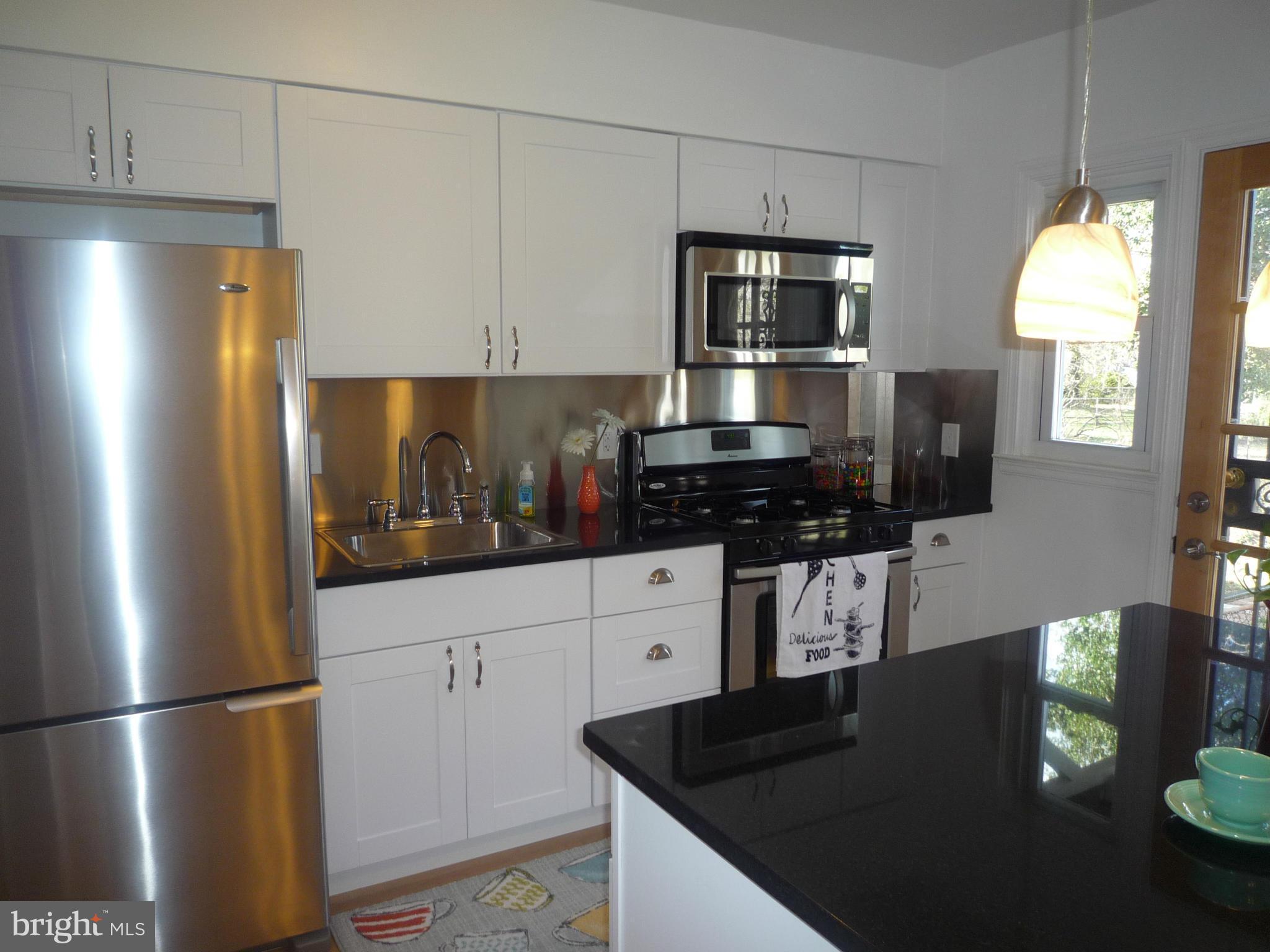 1042 Upnor Road Baltimore, MD 21212 - Photo 13 of 30 a kitchen with a refrigerator and a stove top oven