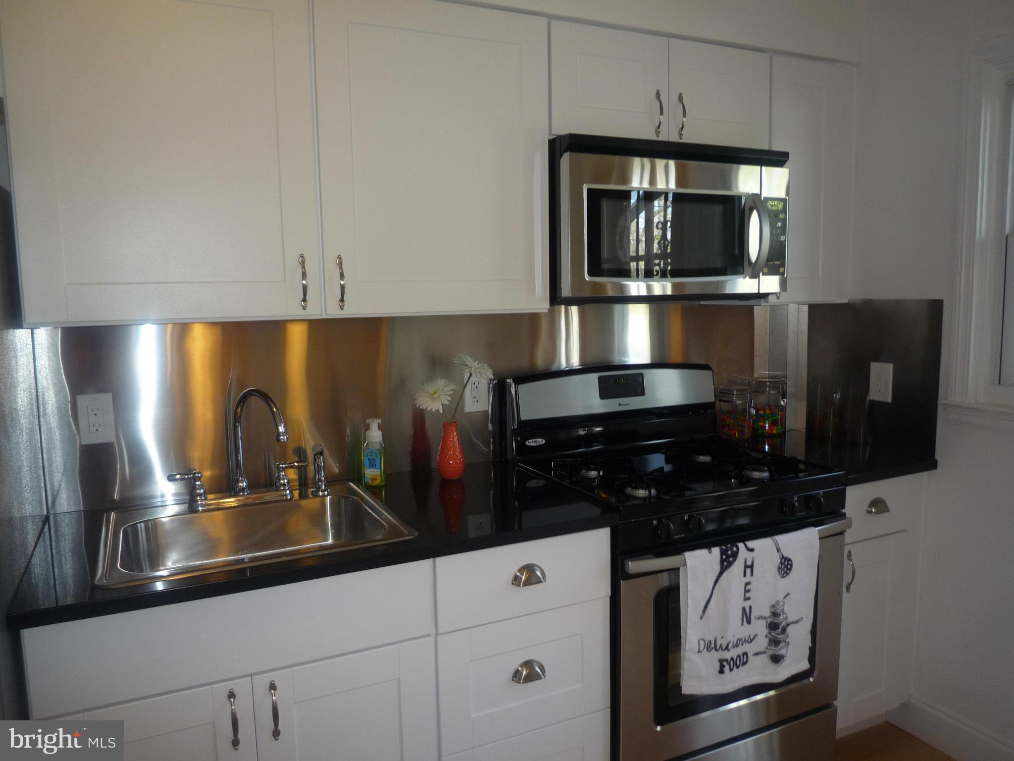 1042 Upnor Road Baltimore, MD 21212 - Photo 14 of 30 a kitchen with a sink and cabinets