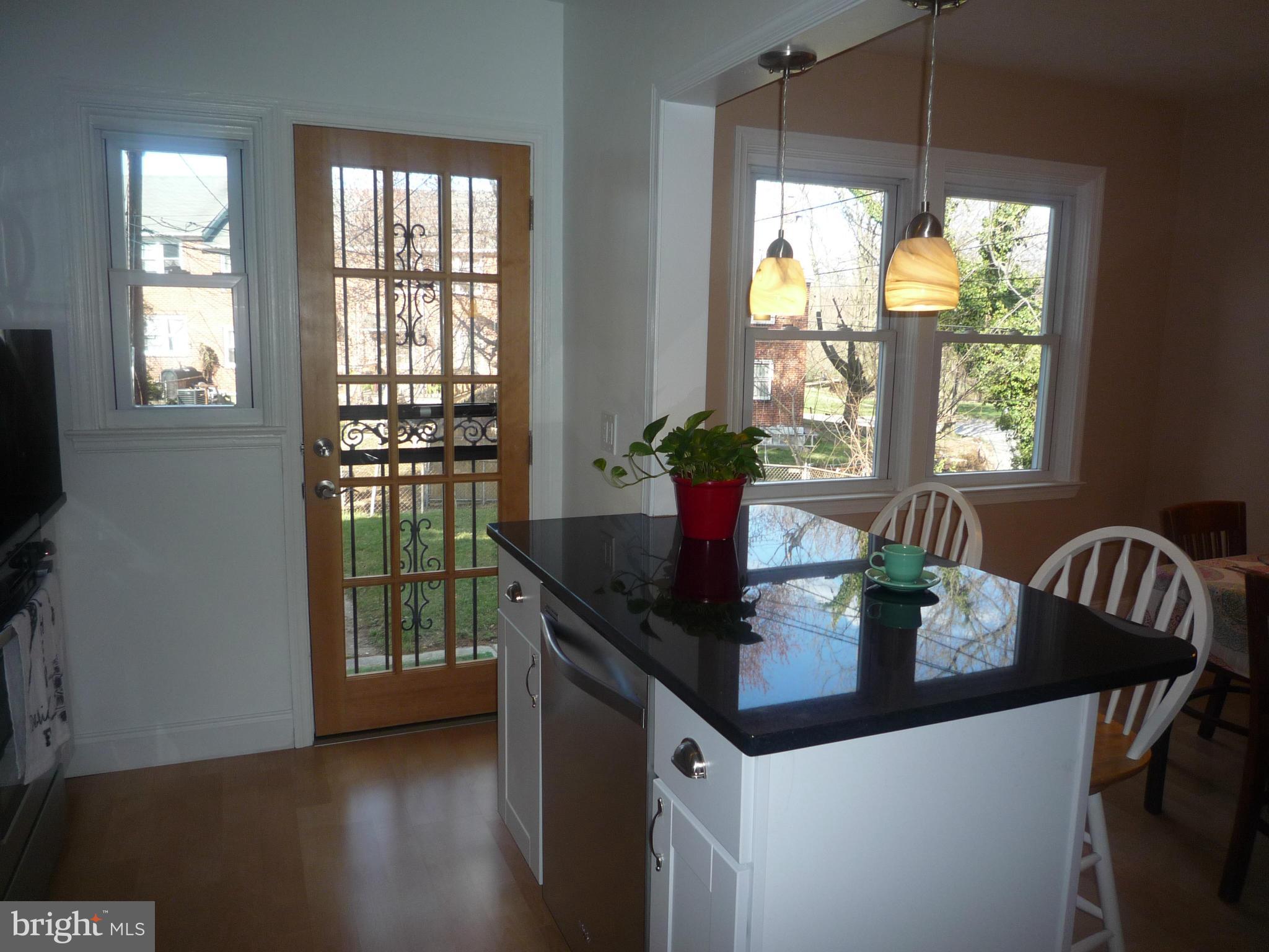 1042 Upnor Road Baltimore, MD 21212 - Photo 15 of 30 a dining room with furniture a chandelier and wooden floor