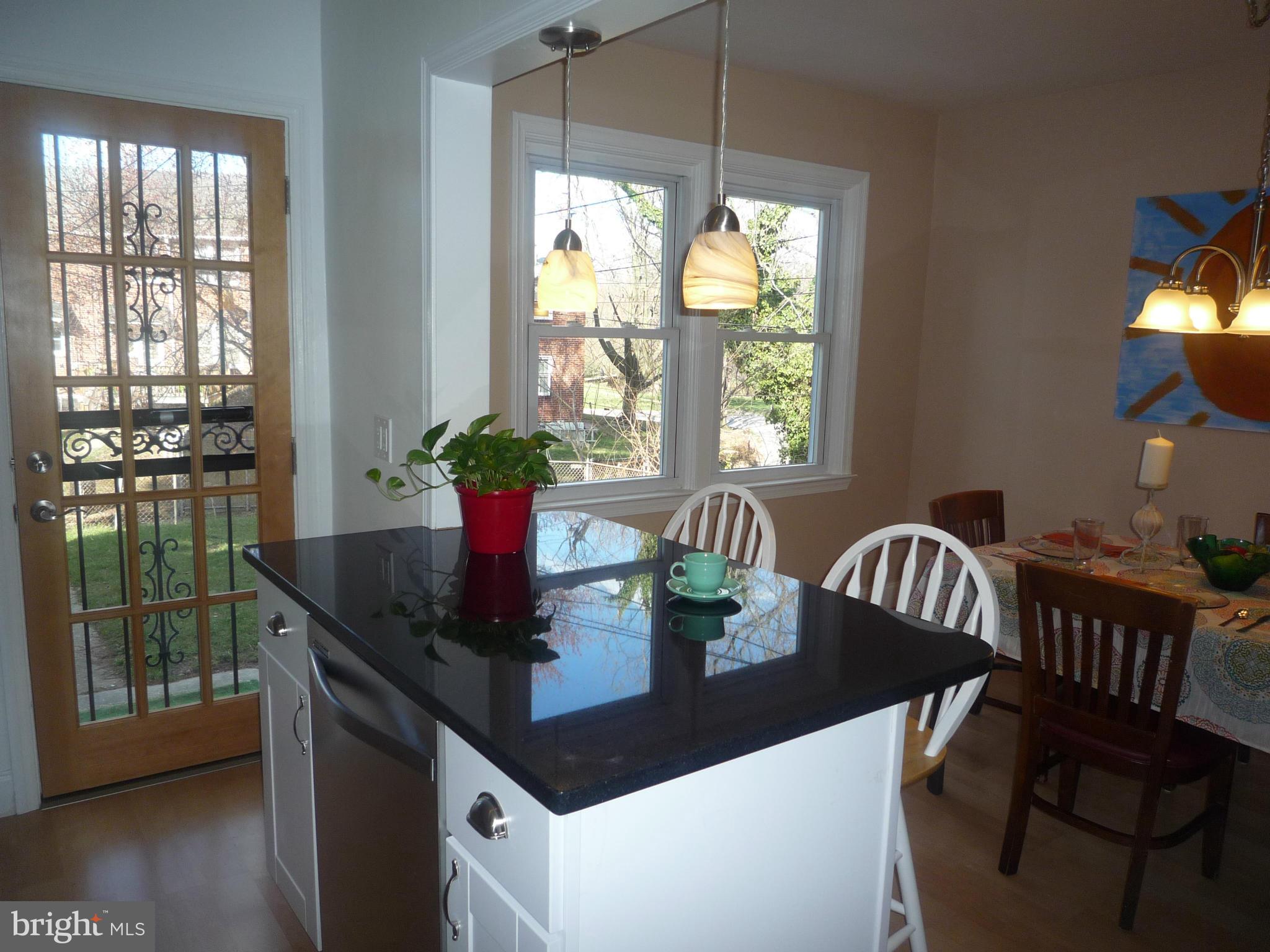 1042 Upnor Road Baltimore, MD 21212 - Photo 16 of 30 a kitchen with a table chairs and wooden floor
