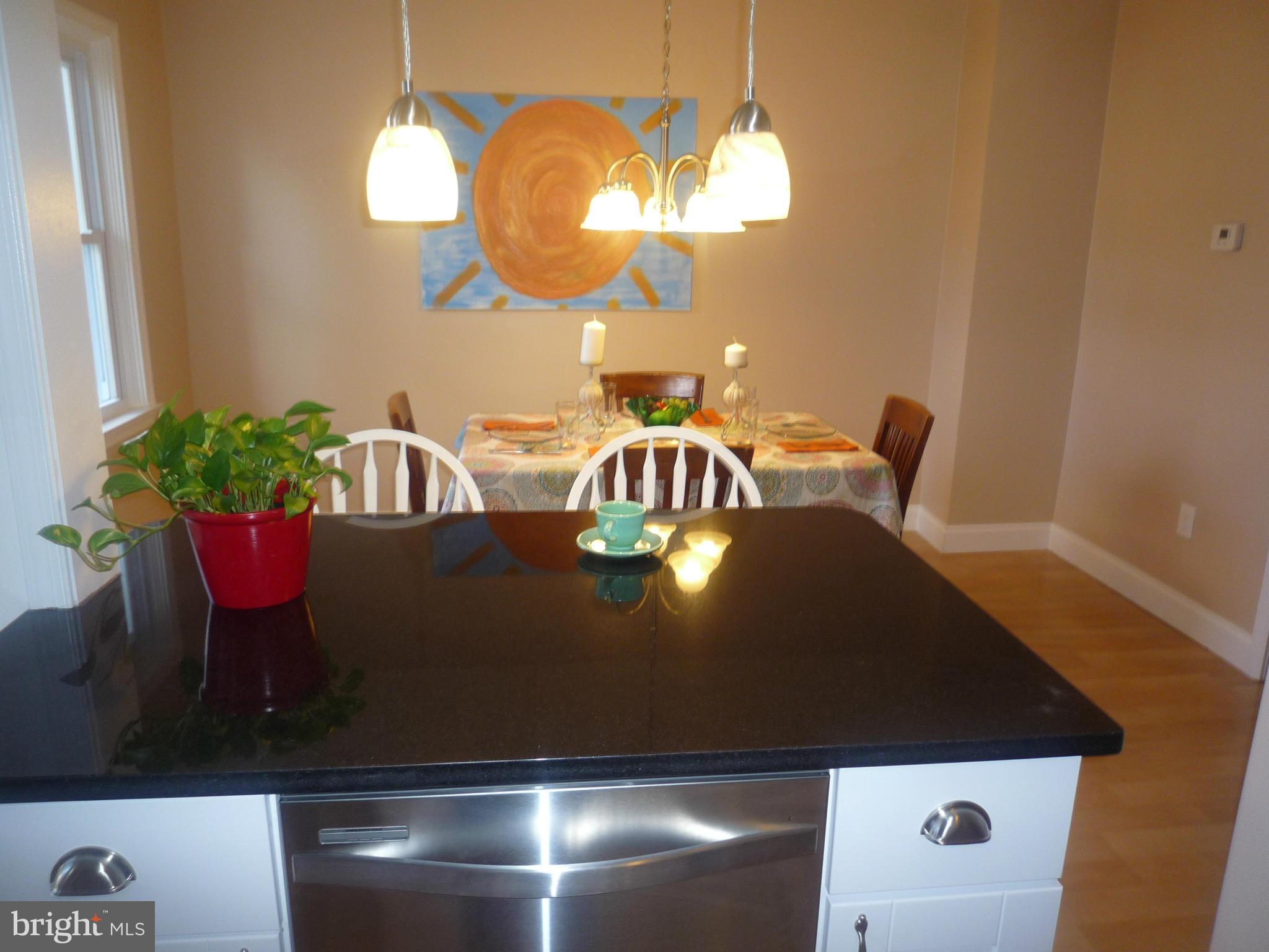 1042 Upnor Road Baltimore, MD 21212 - Photo 17 of 30 a view of a dining room with furniture and wooden floor