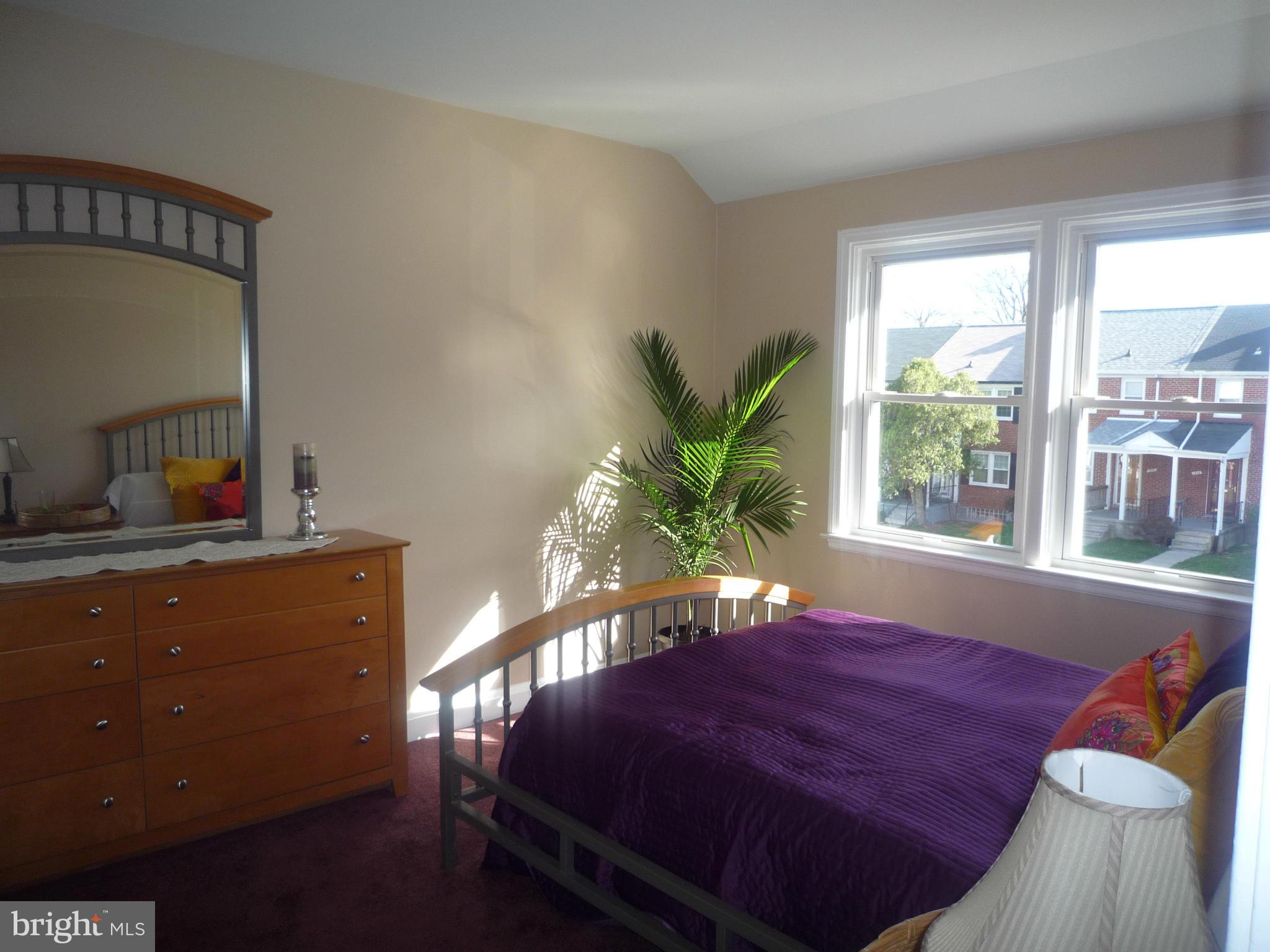 1042 Upnor Road Baltimore, MD 21212 - Photo 19 of 30 a large bed sitting in a bedroom next to a window