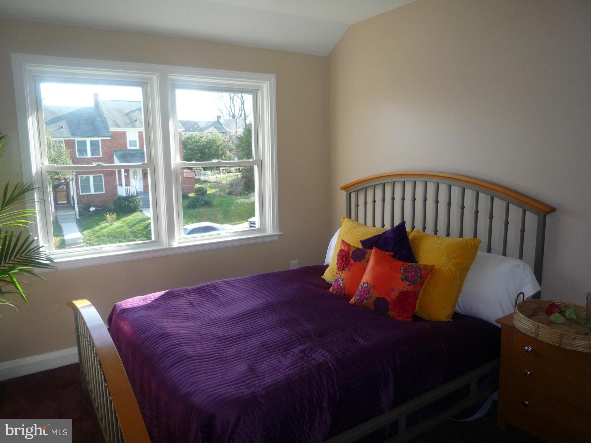 1042 Upnor Road Baltimore, MD 21212 - Photo 20 of 30 a bed sitting in a bedroom next to a window