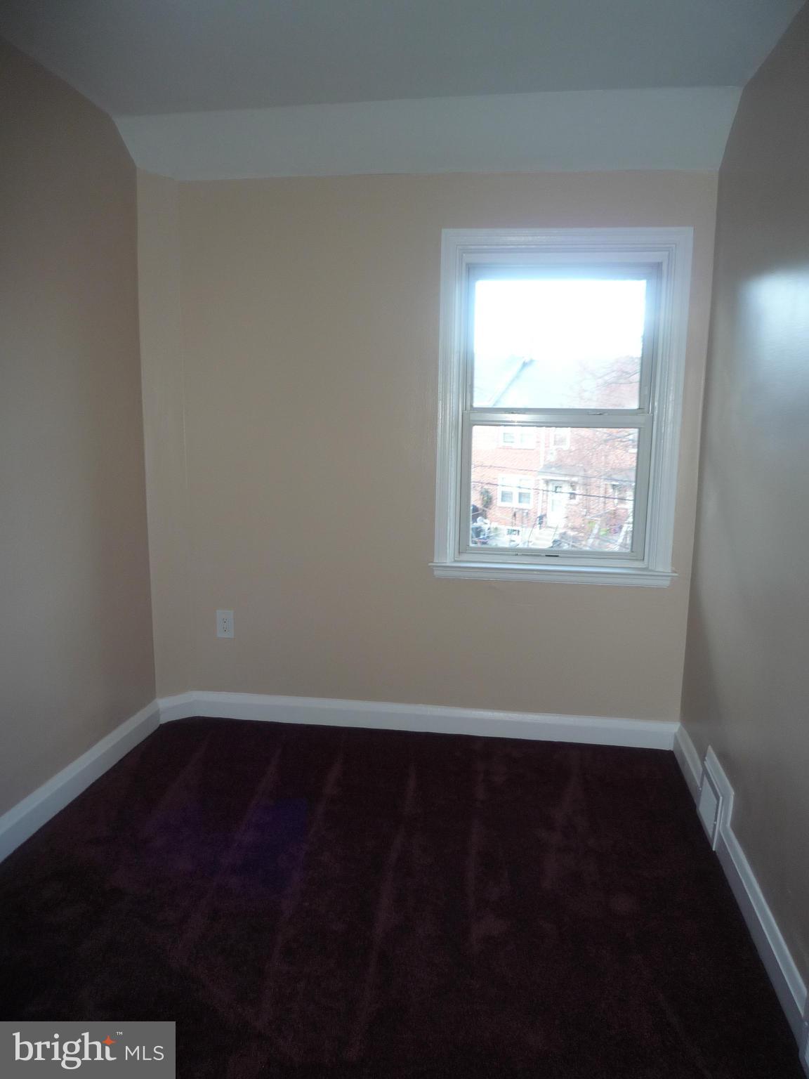 1042 Upnor Road Baltimore, MD 21212 - Photo 22 of 30 a view of an empty room with wooden floor and a window