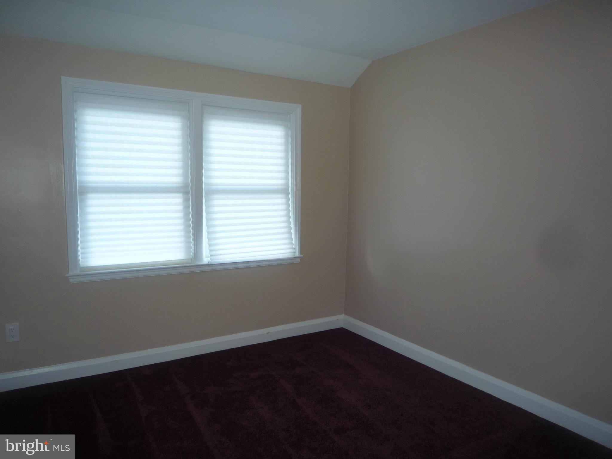 1042 Upnor Road Baltimore, MD 21212 - Photo 25 of 30 an empty room with wooden floor and windows