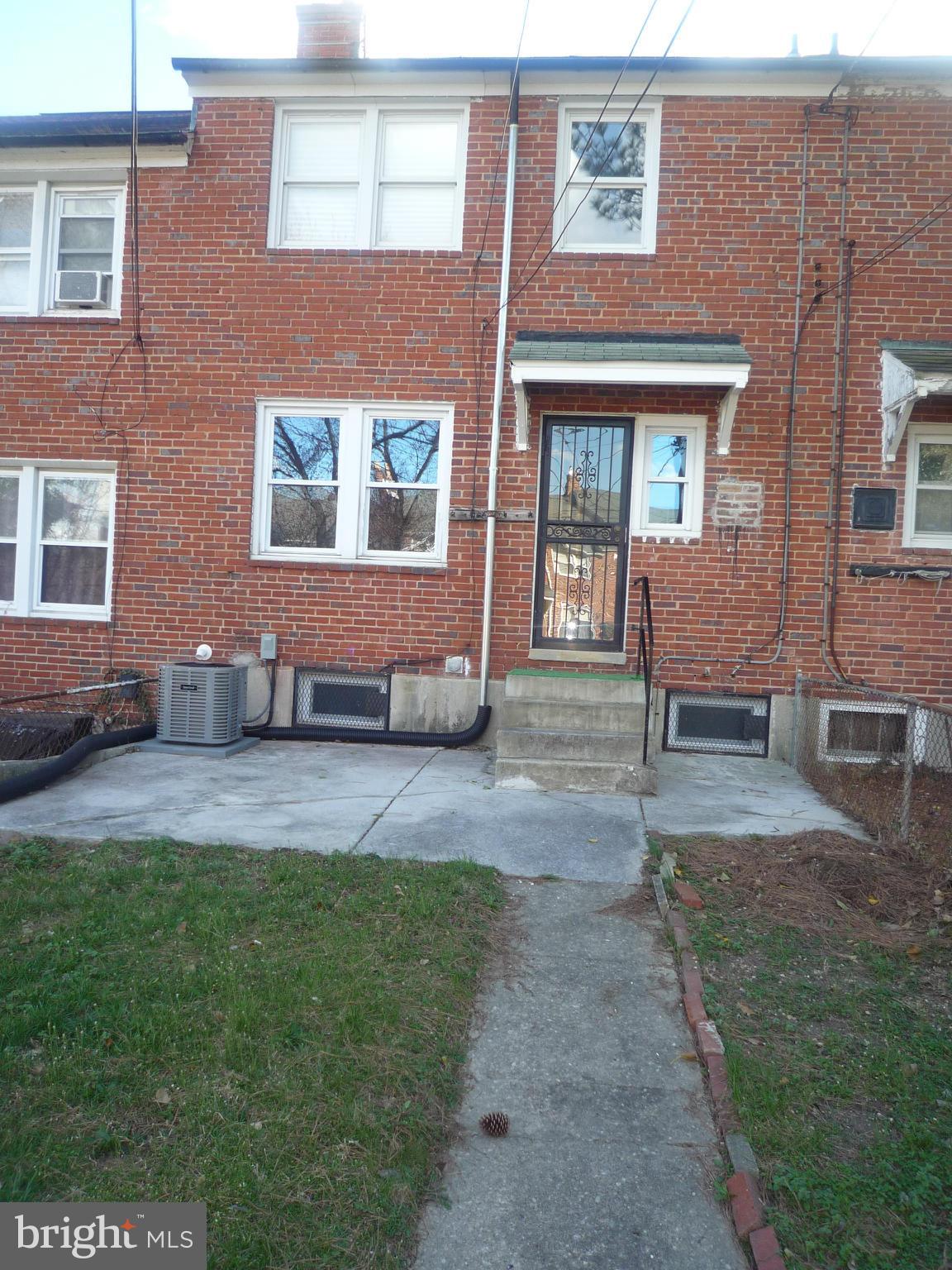1042 Upnor Road Baltimore, MD 21212 - Photo 30 of 30 a front view of a house with a garden and patio