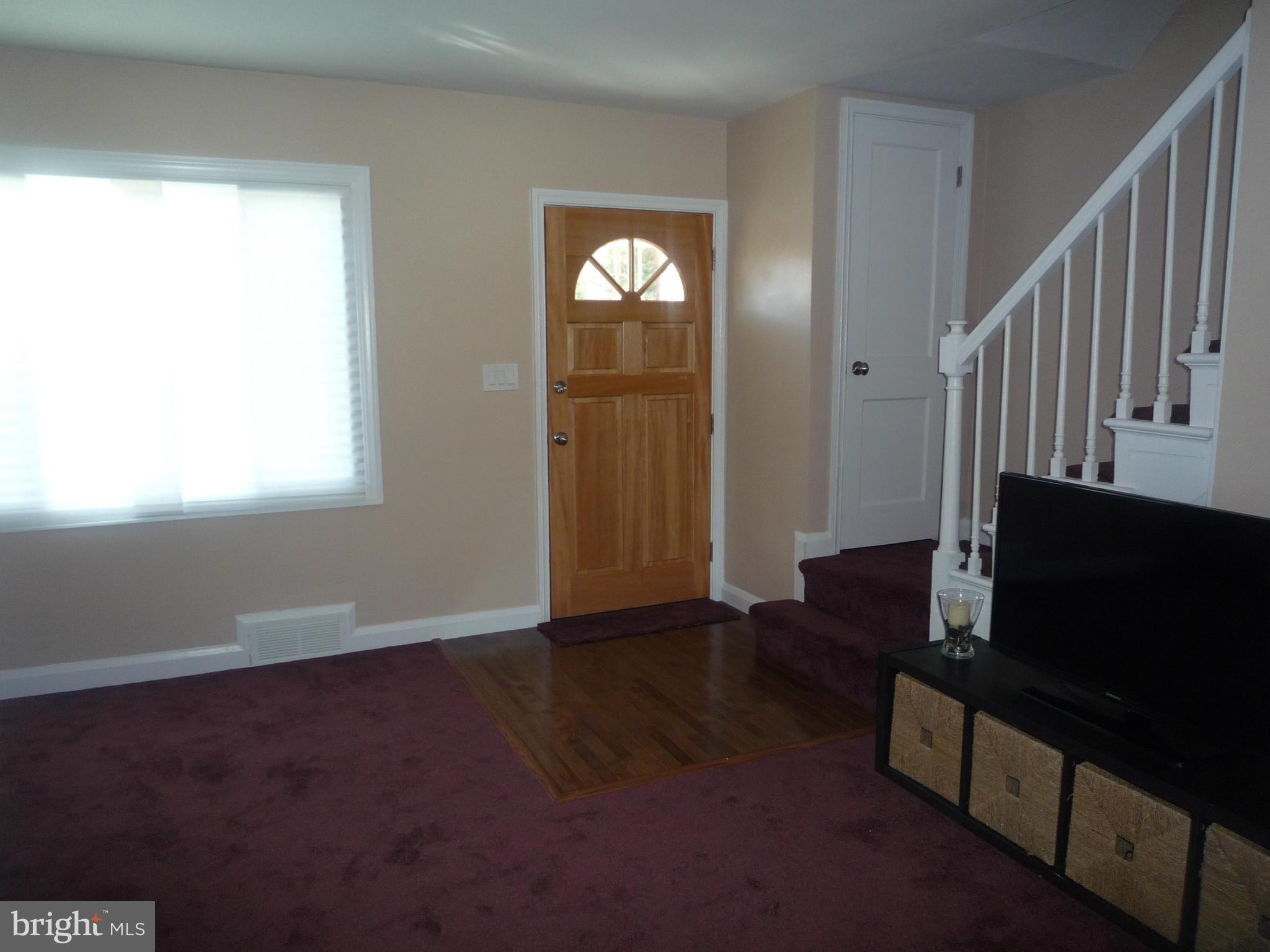 1042 Upnor Road Baltimore, MD 21212 - Photo 8 of 30 a view of an empty room with wooden floor and a window