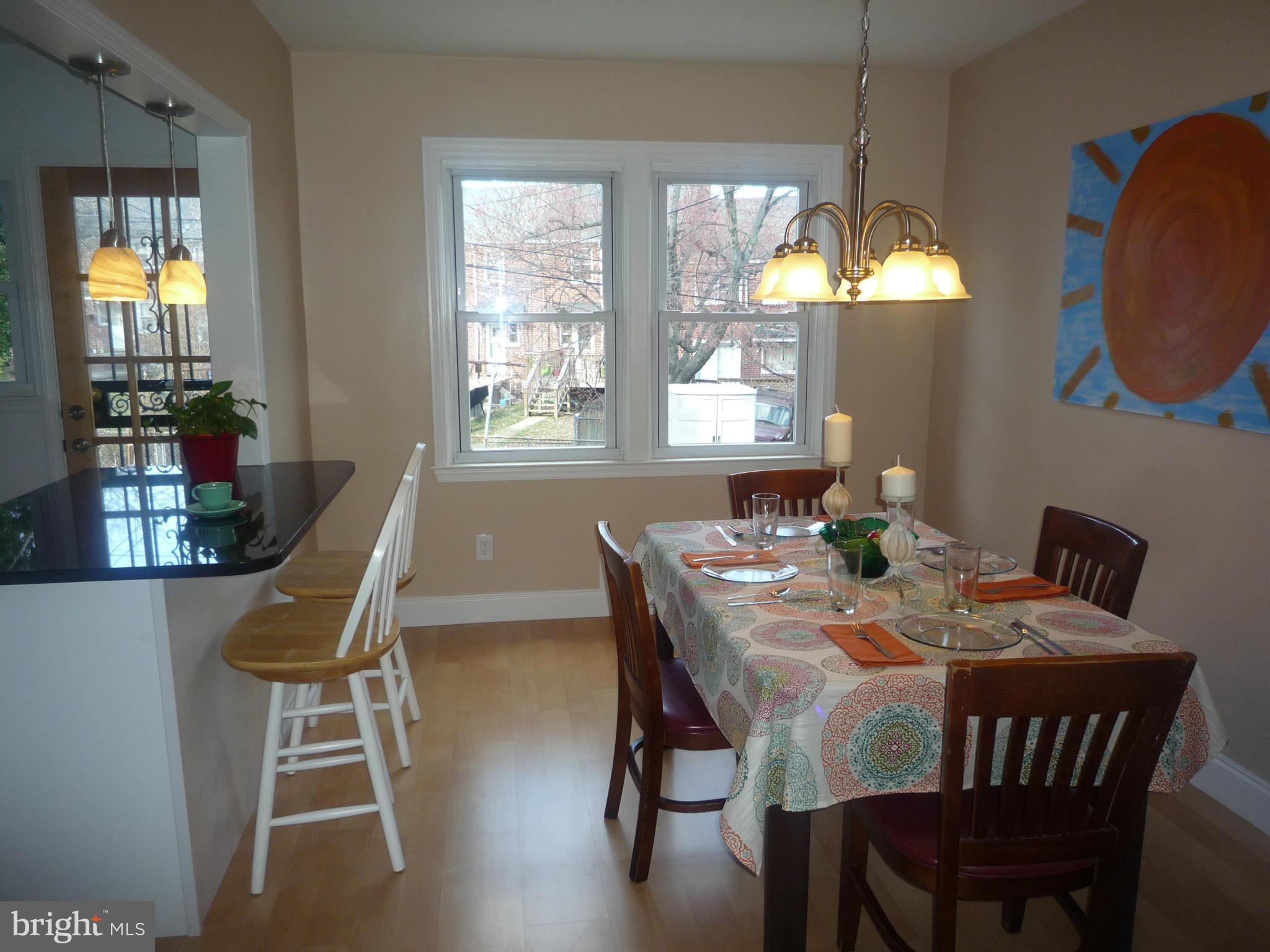 1042 Upnor Road Baltimore, MD 21212 - Photo 10 of 30 a view of a dining room with furniture wooden floor and chandelier