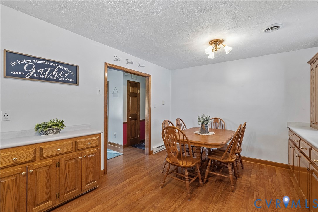 18024 Sandy Ford Road Petersburg, VA 23803 - Photo 21 of 66 a view of a dining room with furniture wooden floor and front door