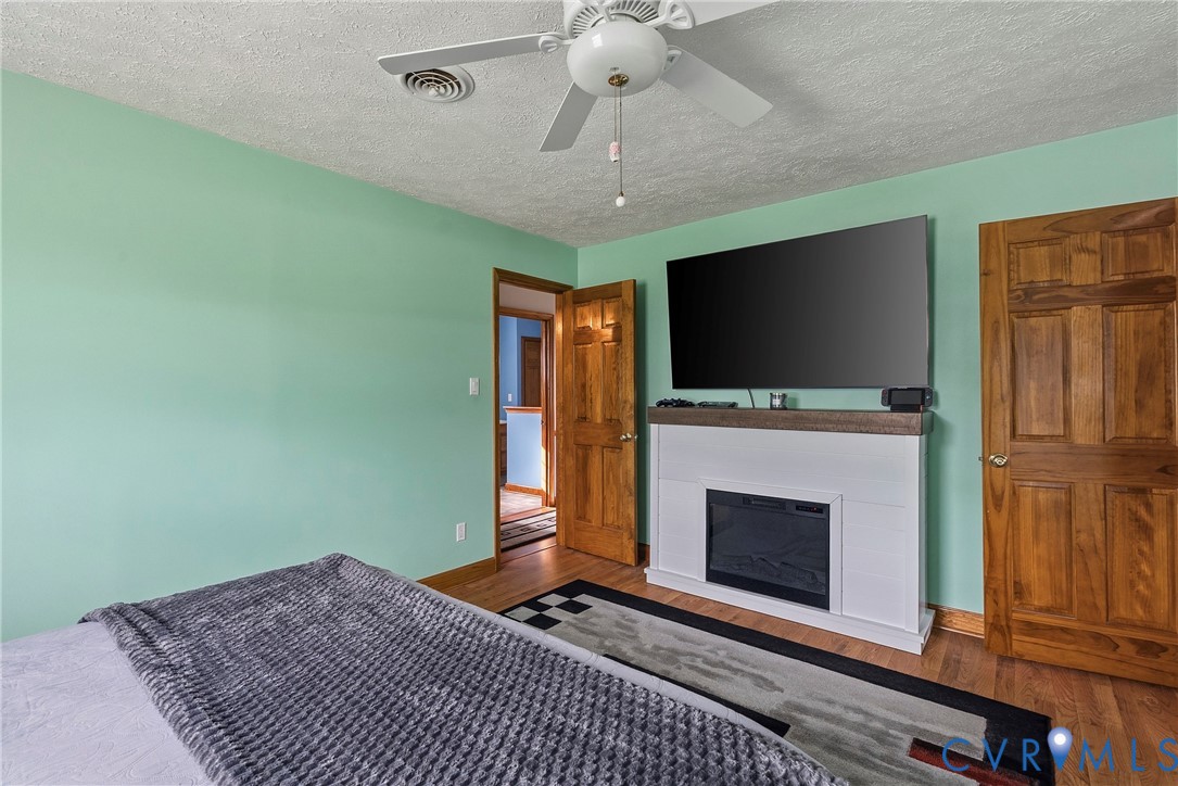 18024 Sandy Ford Road Petersburg, VA 23803 - Photo 26 of 66 a living room with fireplace furniture and a flat screen tv