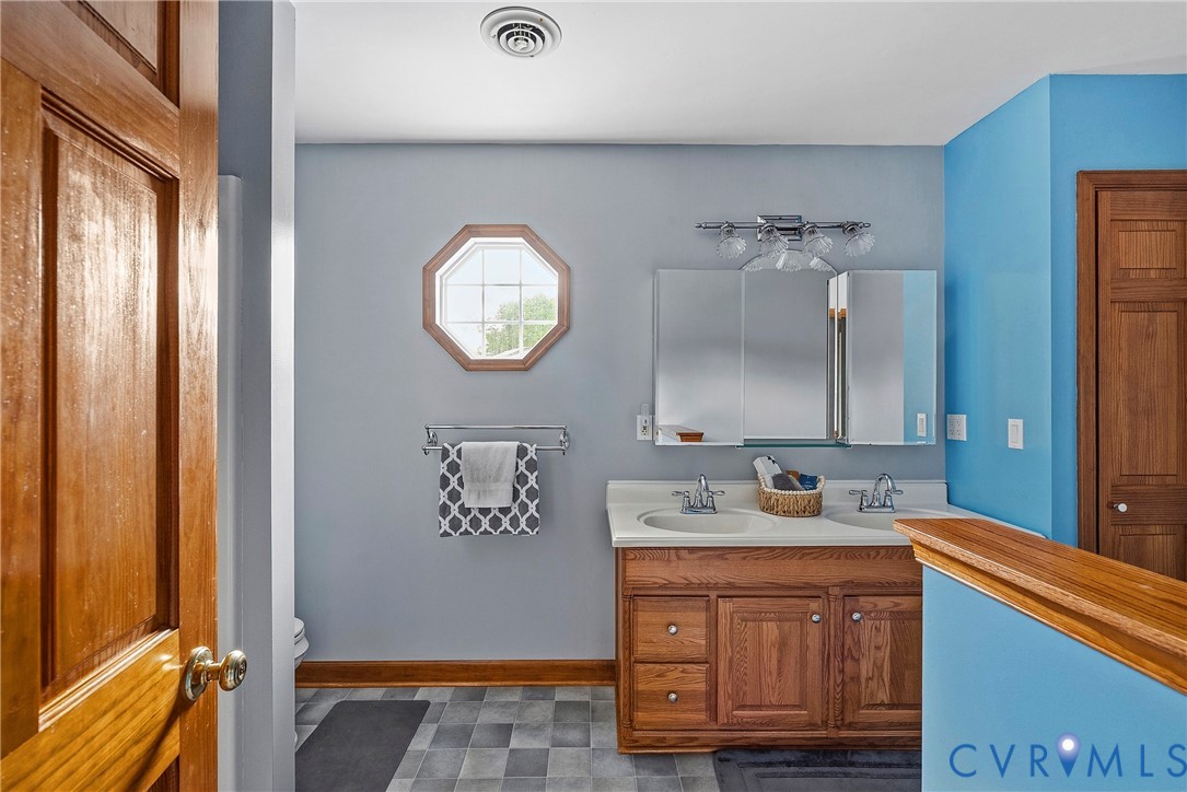 18024 Sandy Ford Road Petersburg, VA 23803 - Photo 28 of 66 a bathroom with a sink and a mirror