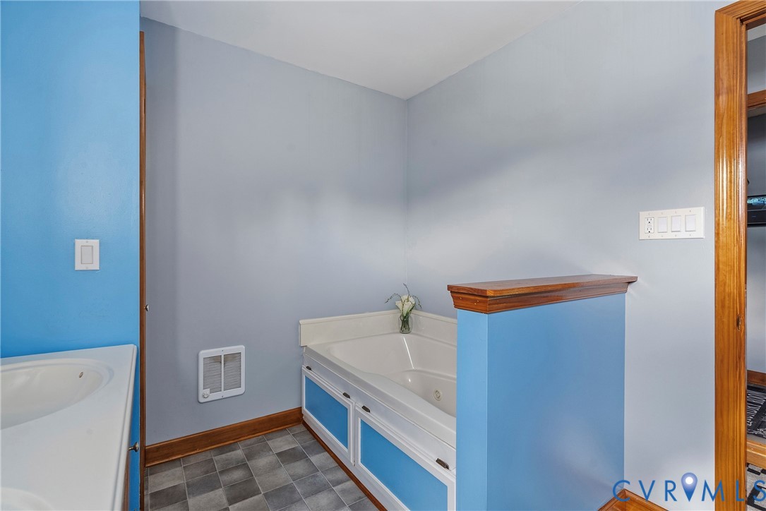 18024 Sandy Ford Road Petersburg, VA 23803 - Photo 30 of 66 a bathroom with a bathtub sink and mirror