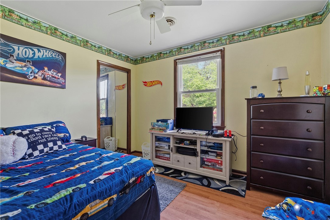 18024 Sandy Ford Road Petersburg, VA 23803 - Photo 34 of 66 a bedroom with a bed and a flat tv screen on dresser