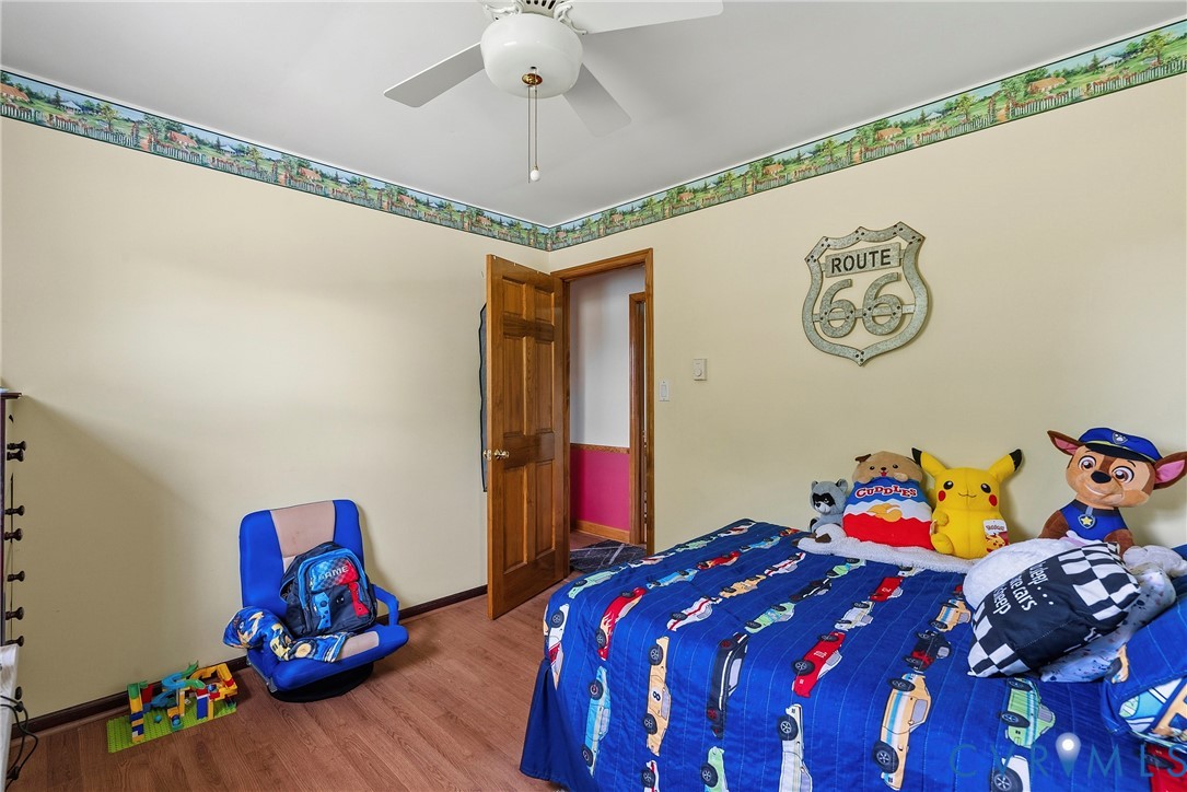 18024 Sandy Ford Road Petersburg, VA 23803 - Photo 35 of 66 a bedroom with a bed and a chandelier