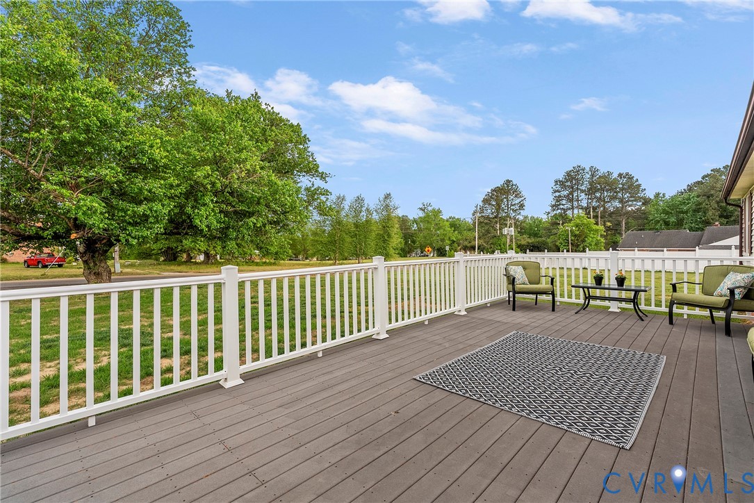 18024 Sandy Ford Road Petersburg, VA 23803 - Photo 38 of 66 a view of a deck with chairs a barbeque with wooden floor and fence