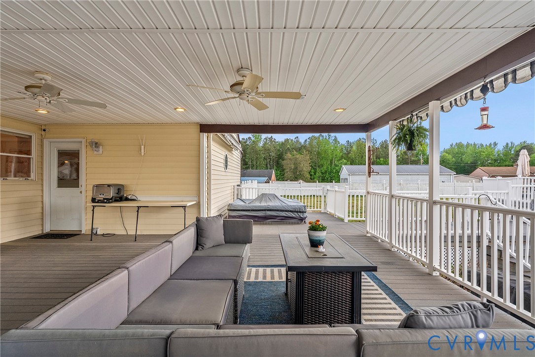 18024 Sandy Ford Road Petersburg, VA 23803 - Photo 43 of 66 a view of a patio with table and chairs with wooden floor and fence