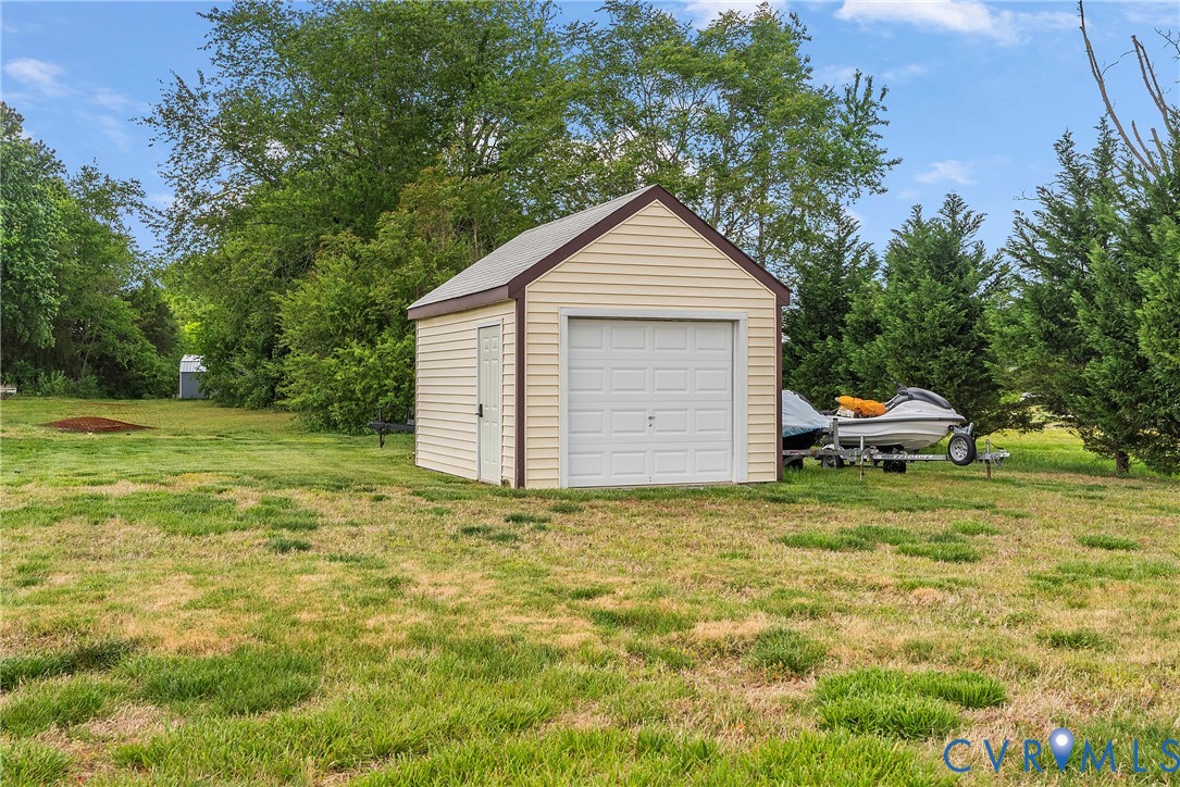 18024 Sandy Ford Road Petersburg, VA 23803 - Photo 56 of 66 a backyard of a house with a garden and barbeque oven
