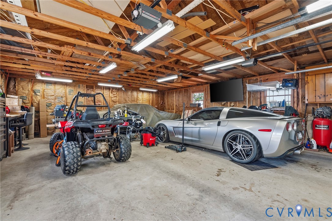 18024 Sandy Ford Road Petersburg, VA 23803 - Photo 57 of 66 a view of a garage with a car and a car