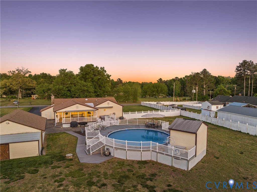 18024 Sandy Ford Road Petersburg, VA 23803 - Photo 58 of 66 a view of swimming pool with outdoor seating and trees in the background