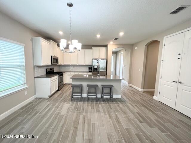 2333 Reese Way Jacksonville, FL 32246 - Photo 11 of 29 a kitchen with granite countertop a stove a sink a dining table and chairs