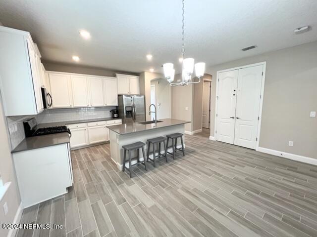 2333 Reese Way Jacksonville, FL 32246 - Photo 12 of 29 a kitchen with stainless steel appliances kitchen island granite countertop a refrigerator a stove a microwave oven a sink with island and chairs