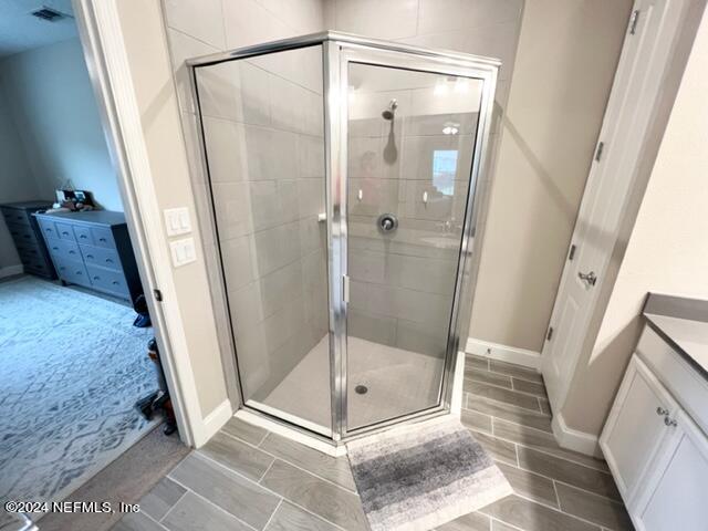 2333 Reese Way Jacksonville, FL 32246 - Photo 18 of 29 a bathroom with a glass door shower and a mirror