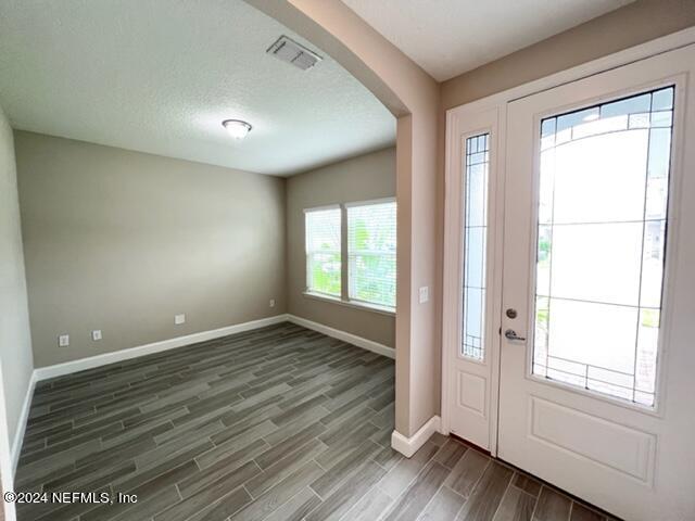 2333 Reese Way Jacksonville, FL 32246 - Photo 3 of 29 an empty room with wooden floor and windows