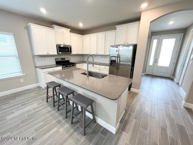 2333 Reese Way Jacksonville, FL 32246 - Photo 6 of 29 a kitchen with stainless steel appliances granite countertop a refrigerator a stove top oven a sink dishwasher a dining table and chairs with wooden floor