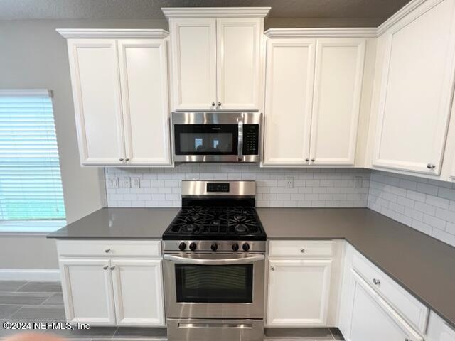 2333 Reese Way Jacksonville, FL 32246 - Photo 8 of 29 a kitchen with stainless steel appliances white cabinets and a stove