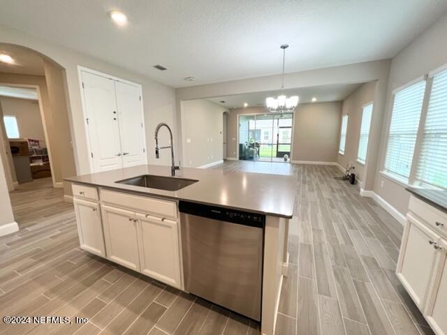 2333 Reese Way Jacksonville, FL 32246 - Photo 9 of 29 a kitchen with granite countertop a stove a sink a refrigerator and white cabinets with wooden floor