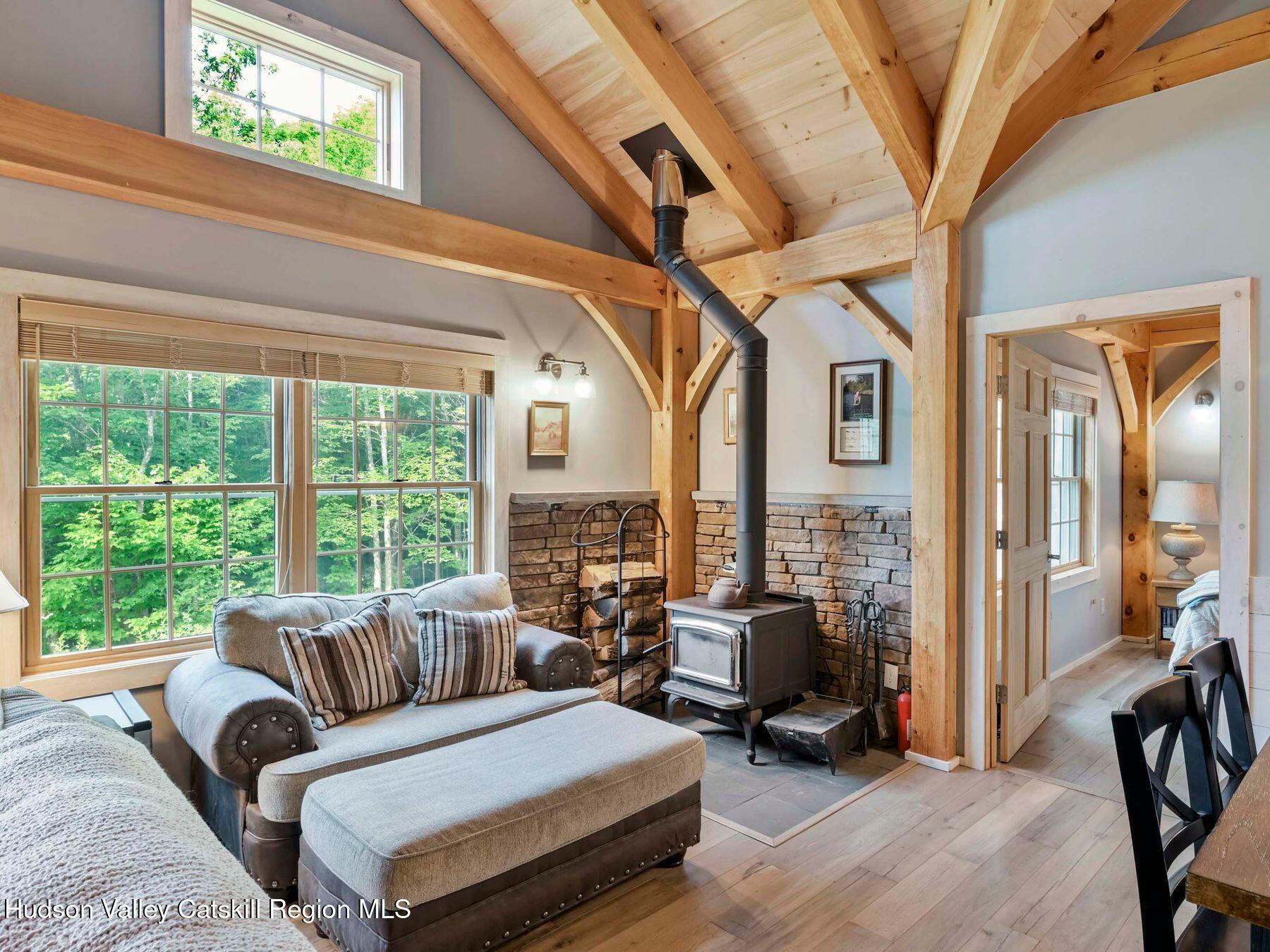 10 County Road Windham, NY 12496 - Photo 12 of 43 a living room with furniture and a large window