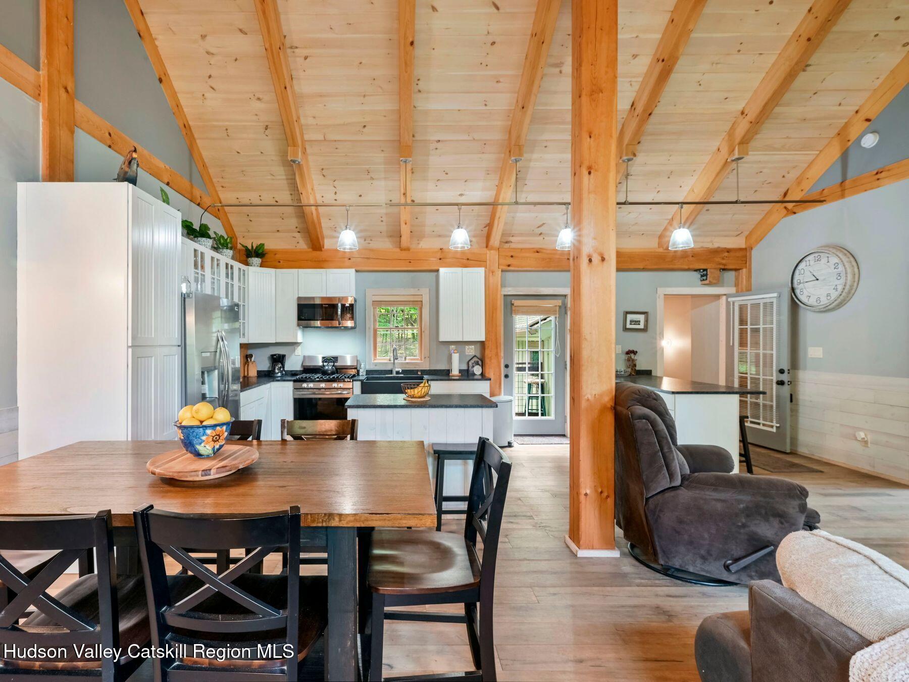 10 County Road Windham, NY 12496 - Photo 13 of 43 a dining room with furniture a rug and wooden floor