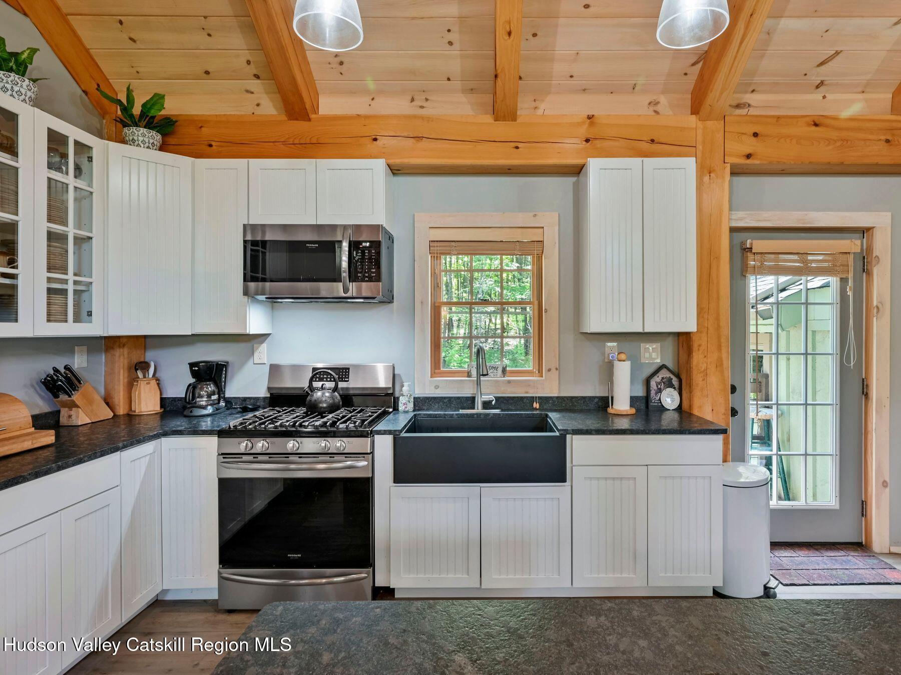 10 County Road Windham, NY 12496 - Photo 15 of 43 a kitchen with stainless steel appliances granite countertop a stove a sink and a microwave