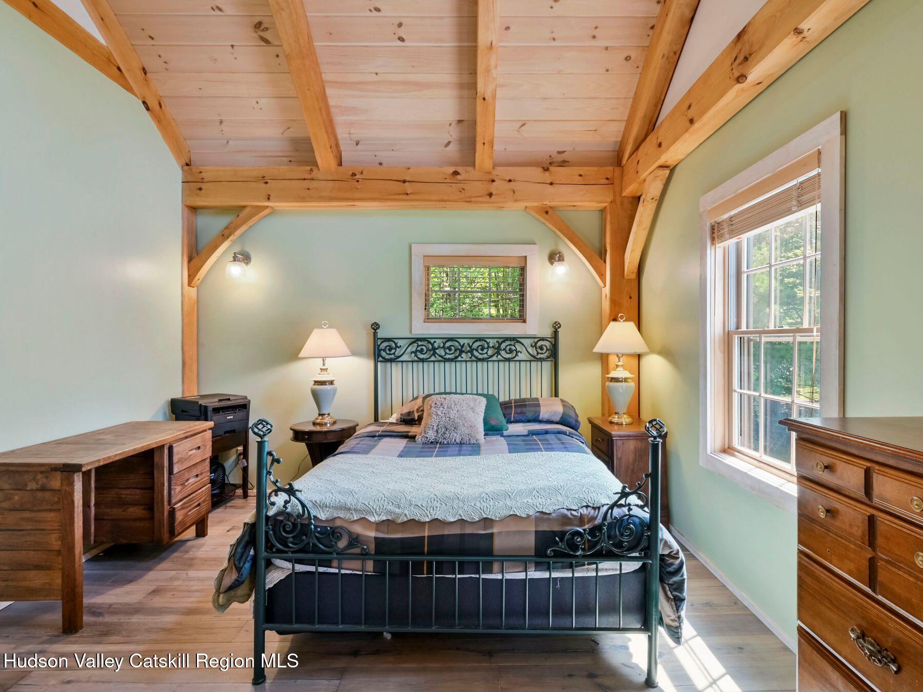 10 County Road Windham, NY 12496 - Photo 20 of 43 a bedroom with a bed a dresser next to a window