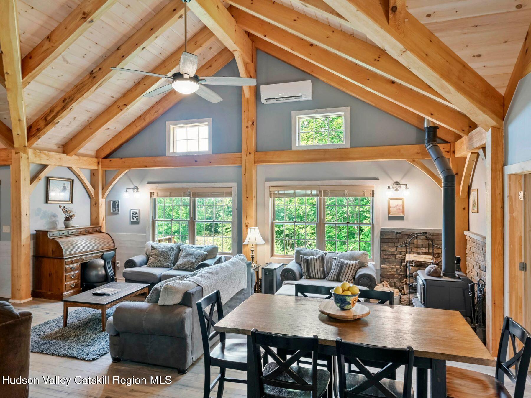 10 County Road Windham, NY 12496 - Photo 2 of 43 a view of a dining room with furniture large windows and wooden floor