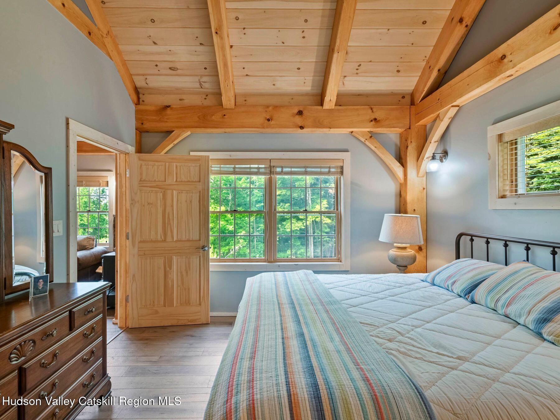 10 County Road Windham, NY 12496 - Photo 22 of 43 a bedroom with a bed and large windows