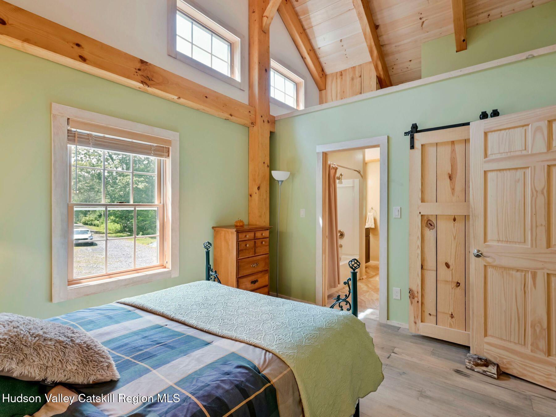 10 County Road Windham, NY 12496 - Photo 26 of 43 a bedroom with a bed and a window