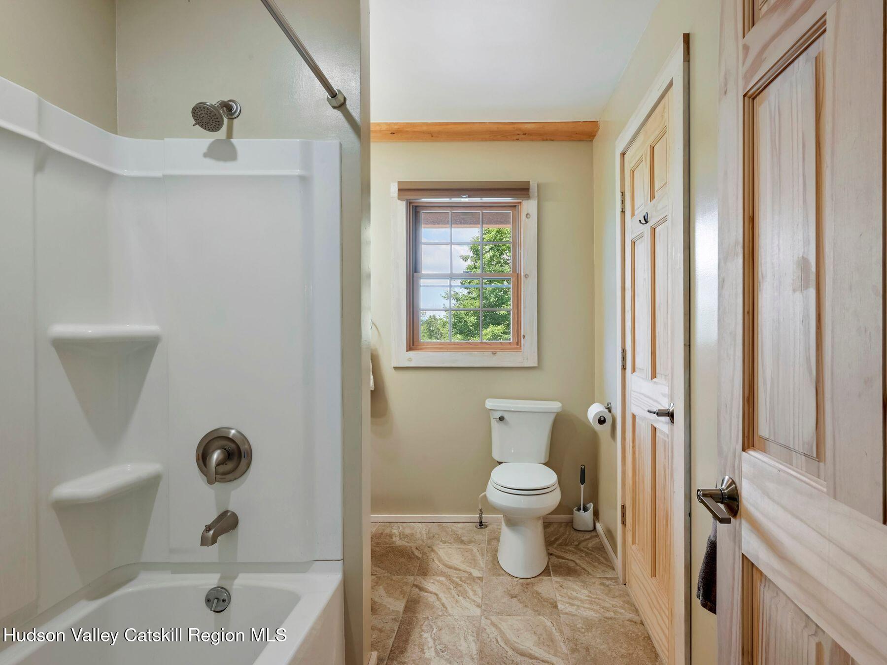 10 County Road Windham, NY 12496 - Photo 27 of 43 a bathroom with a toilet a sink and a shower