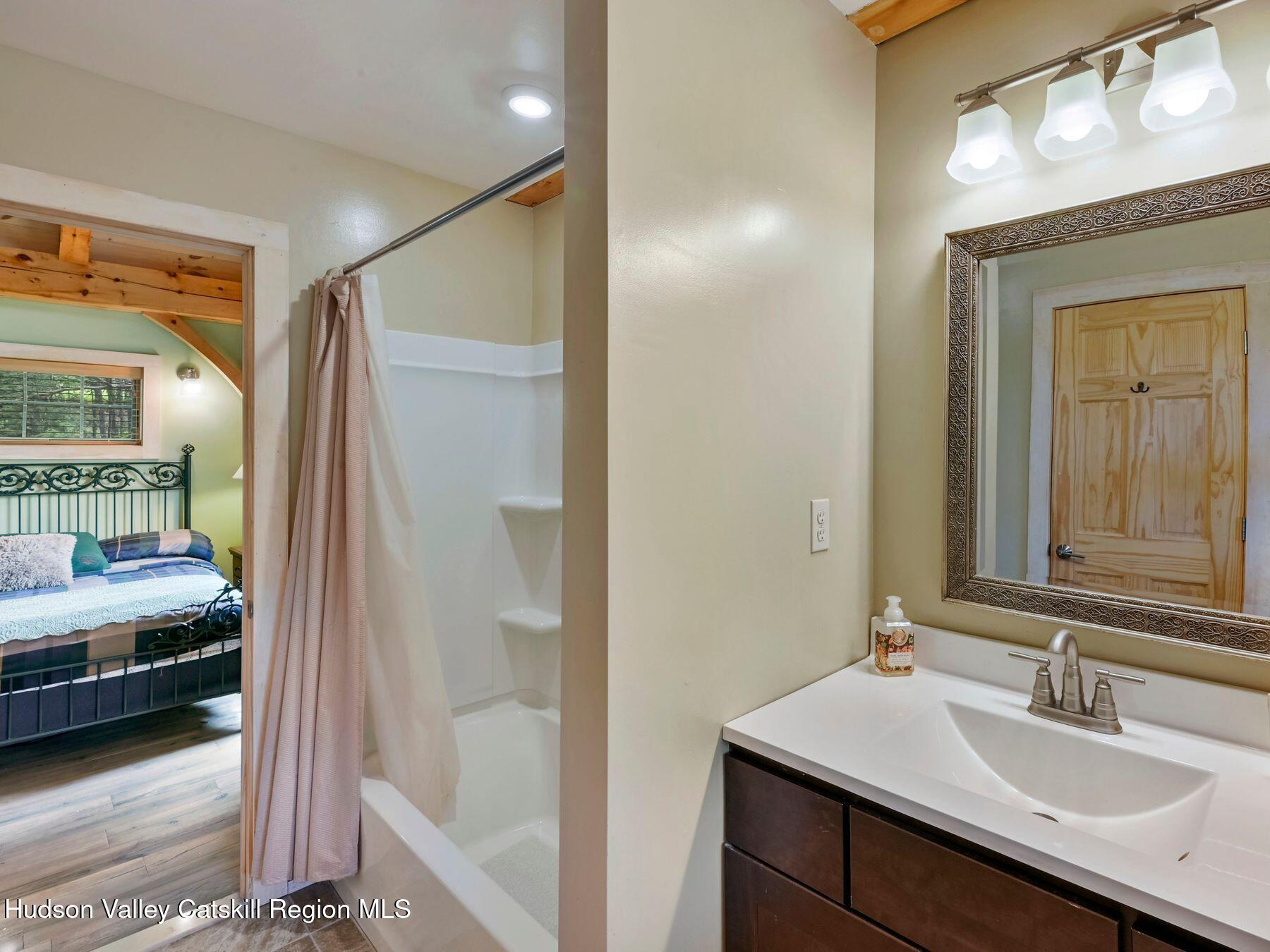 10 County Road Windham, NY 12496 - Photo 28 of 43 a en suite bathroom with a sink and a mirror