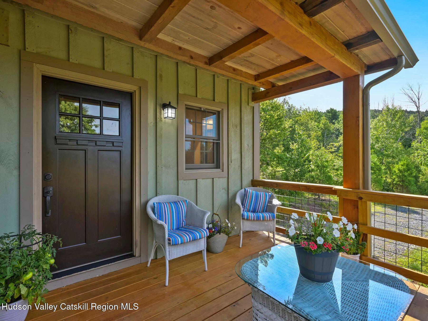 10 County Road Windham, NY 12496 - Photo 3 of 43 a view of a porch with furniture and a potted plant