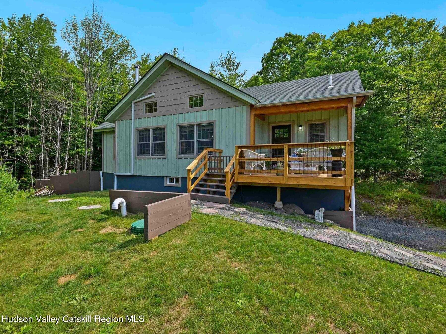 10 County Road Windham, NY 12496 - Photo 41 of 43 a front view of house with a garden and sitting area