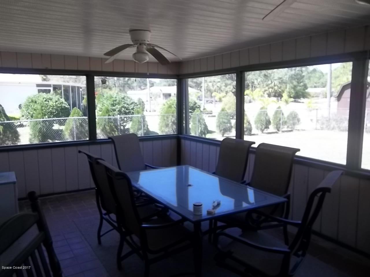 1081 Sapulpa Road Southwest Palm Bay, FL 32908 - Photo 4 of 10 a view of a dining room with furniture window and wooden floor