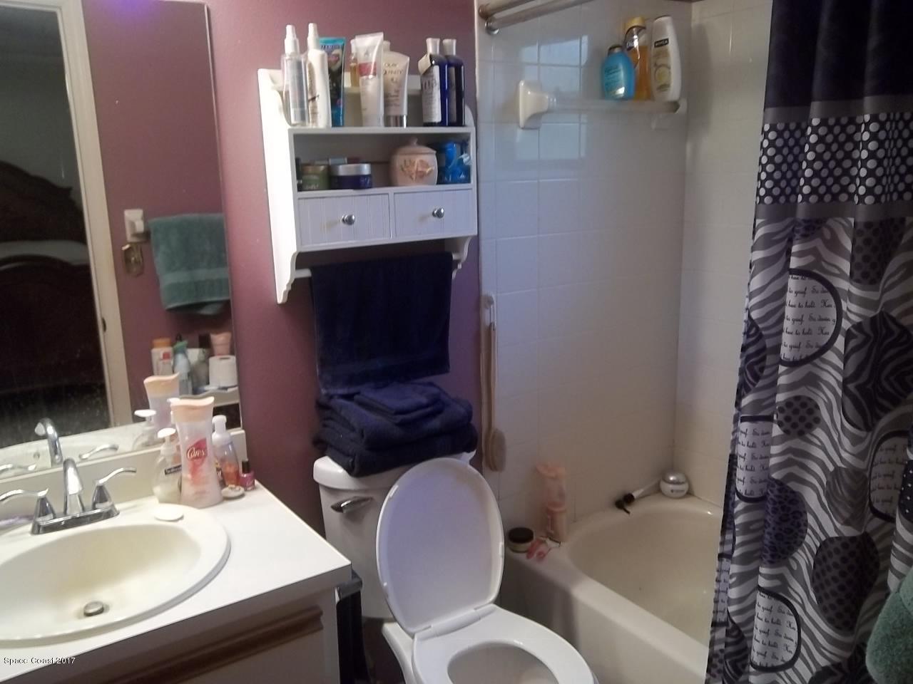 1081 Sapulpa Road Southwest Palm Bay, FL 32908 - Photo 6 of 10 a bathroom with a toilet sink and mirror