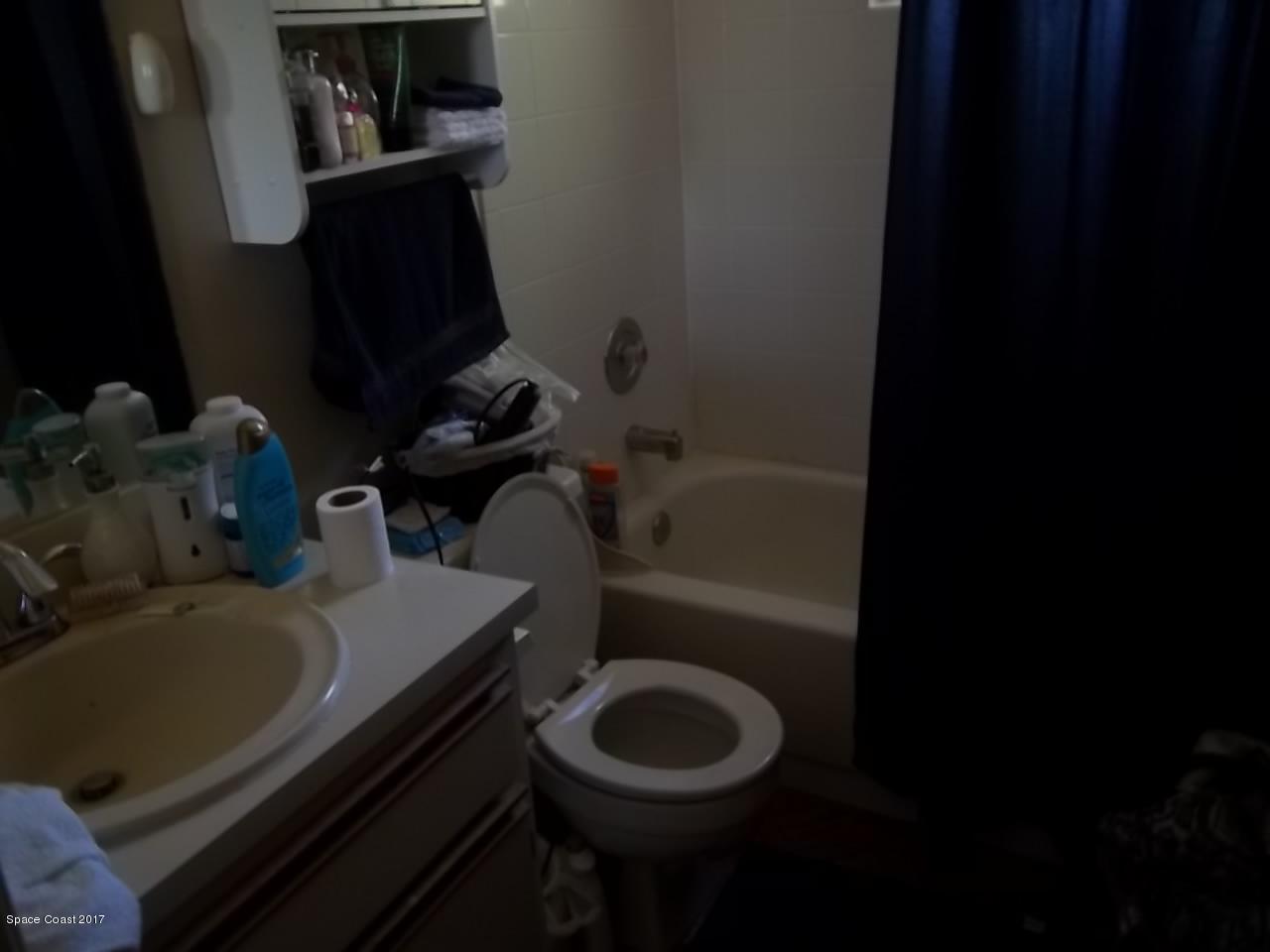 1081 Sapulpa Road Southwest Palm Bay, FL 32908 - Photo 8 of 10 a bathroom with a sink toilet and a mirror