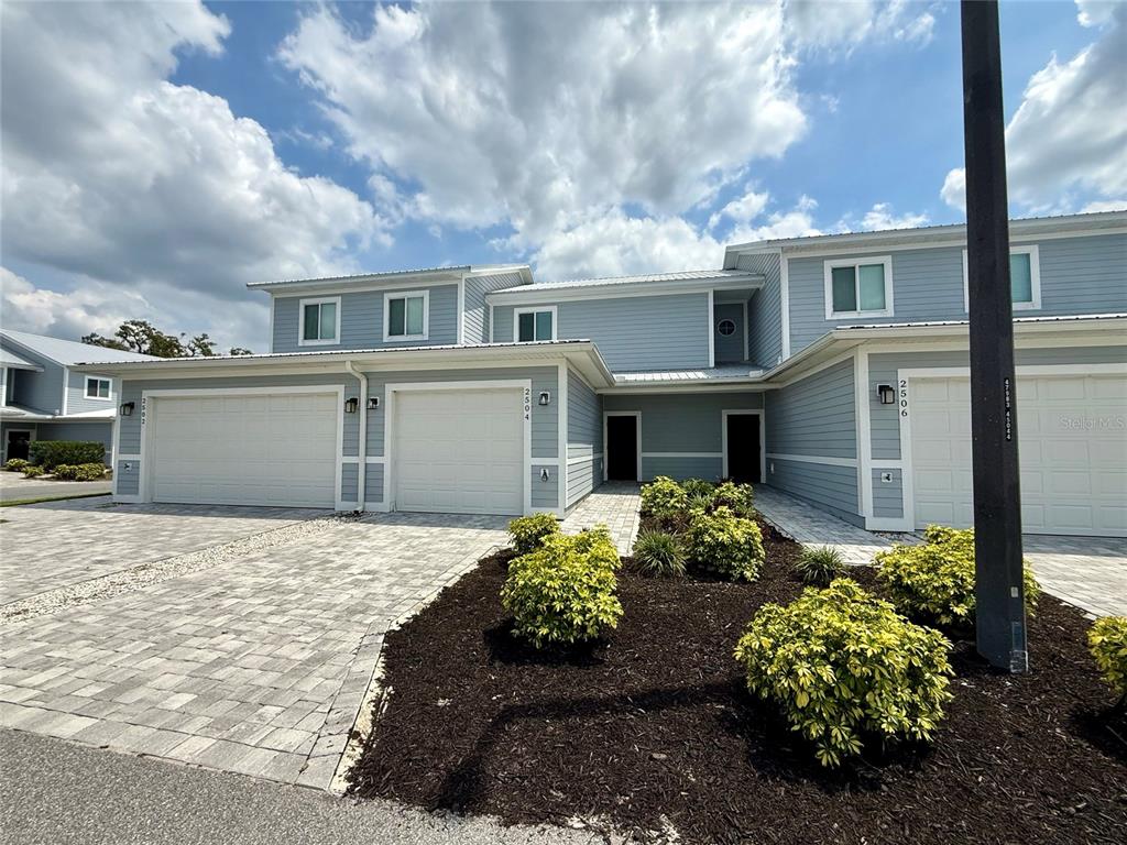 a front view of a house with a yard and a garage