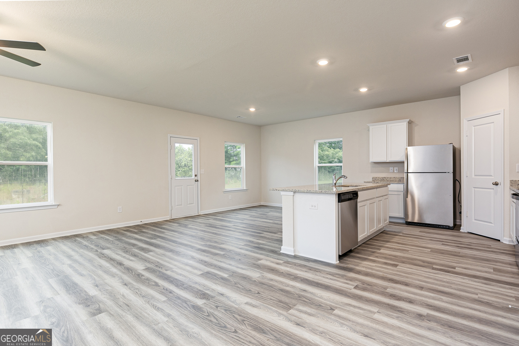 634 Slate Road Conyers, GA 30013 - Photo 6 of 22 a kitchen with refrigerator and wooden floor