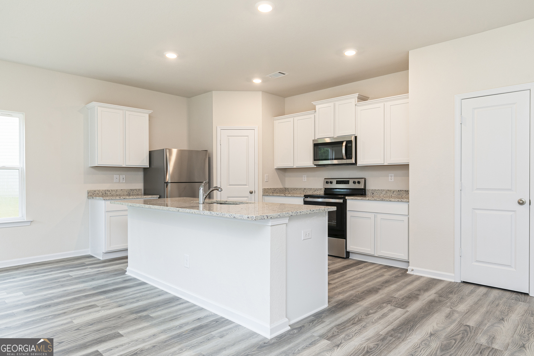 634 Slate Road Conyers, GA 30013 - Photo 9 of 22 a kitchen with granite countertop a refrigerator stove top oven and sink