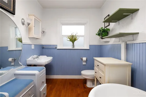 a bathroom with a toilet a sink and a mirror